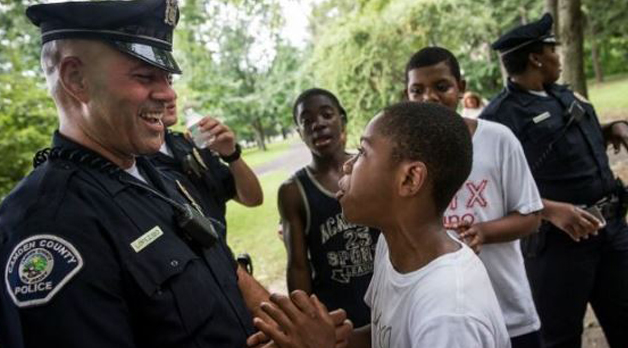 young teen boys talking happily with police officers